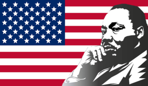 Martin Luther King in thought with American flag in the background