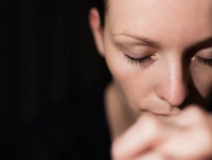 Sad young woman praying. Hope concept.