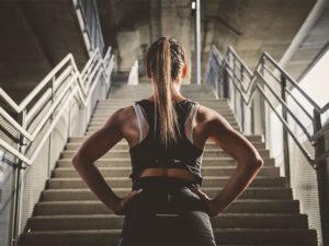 Girl looks at stairs and prepairing for workout